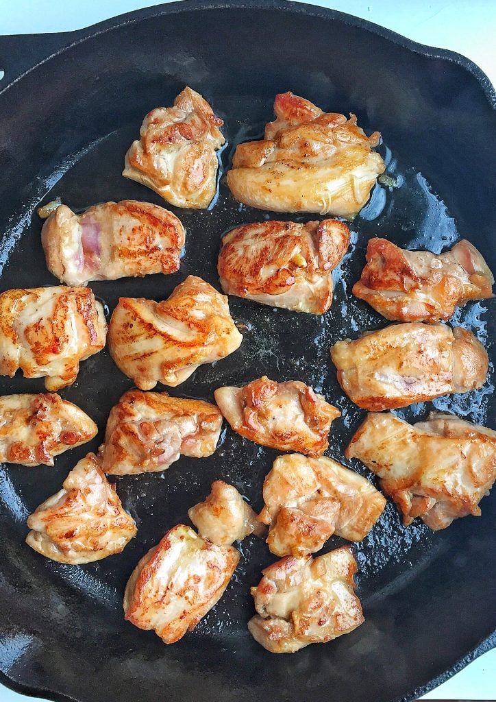 browned chicken in cast iron skillet