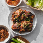 korean chicken bulgogi on plate with green onions