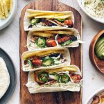 Gochujang Chicken Tacos on a brown cutting board