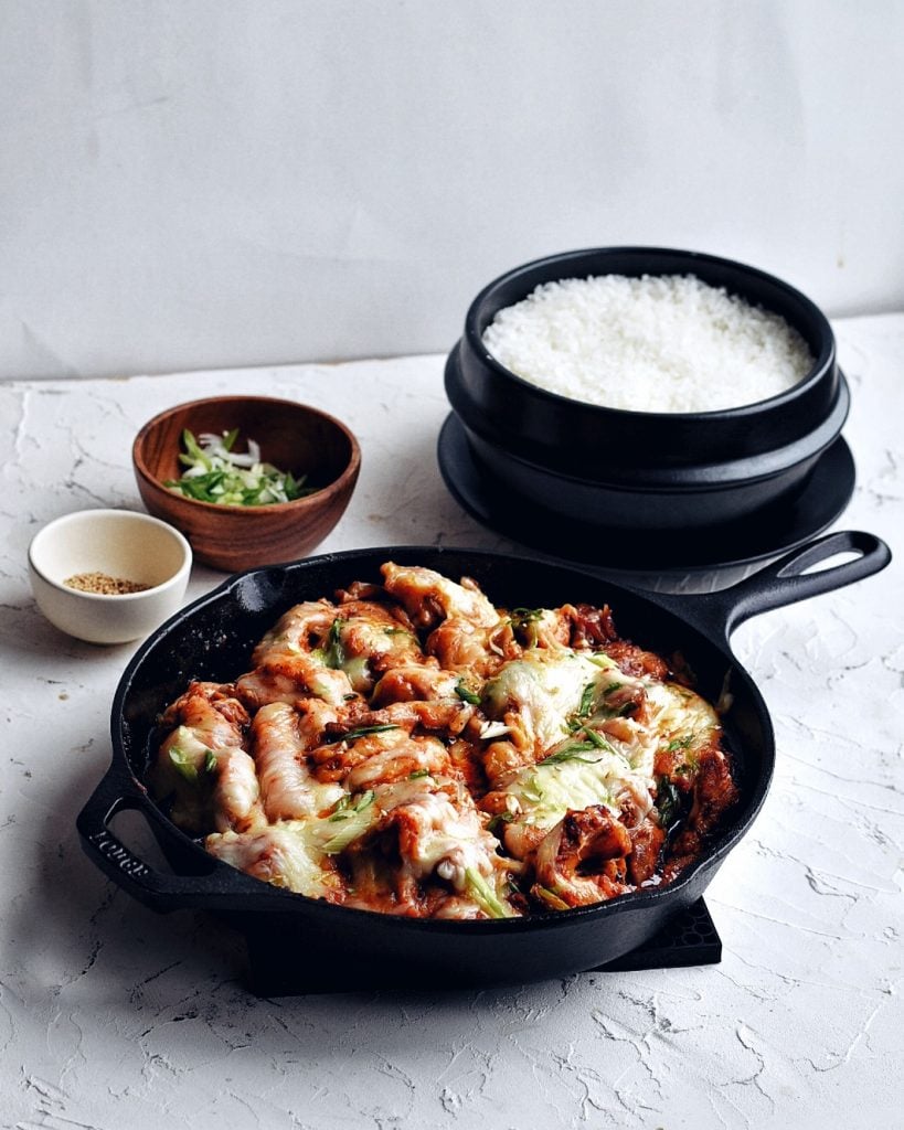 cheese buldak in skillet with rice pot in background