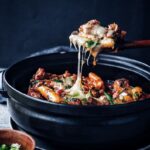 spoon pulling up cheesy spicy galbi jjim