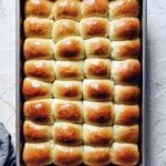 baking pan full of brown, shiny dinner rolls