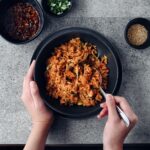 bowl of kongnamul bap with two hands