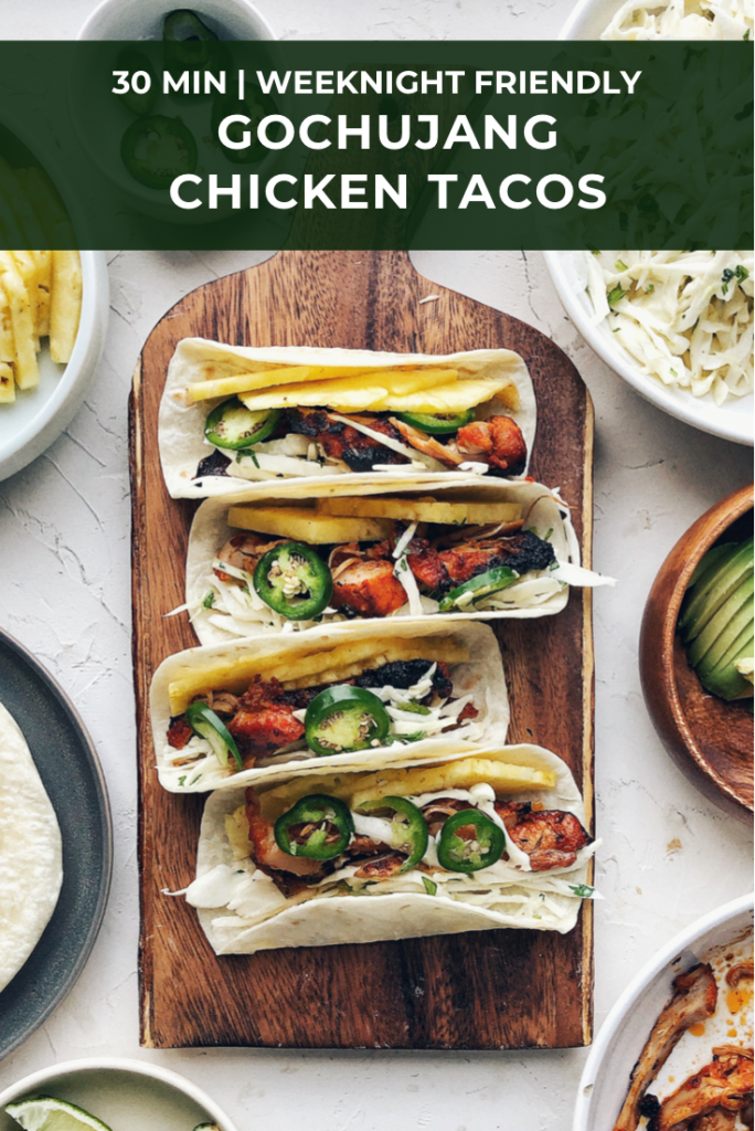 Gochujang chicken tacos on wood board