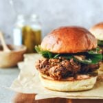 korean fried chicken sandwich on cutting board