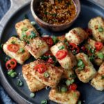 close up of air fryer panko tofu with green onions and red chili pepper