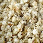 close up of parmesan popcorn with black pepper