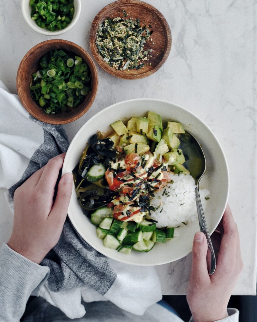 salmon poke bowl on table with napkin
