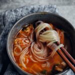 korean chicken soup (dak gomtang) with glass noodles in bowl