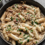 carbonara-style korean rice cakes (tteokbokki) in grey bowl