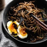buckwheat soba noodles in black bowl with chopsticks