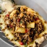 thai pineapple fried rice in a pineapple boat