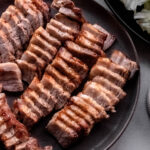 platter of thinly sliced pork belly