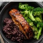 miso glazed salmon in bowl with purple rice and steamed broccoli