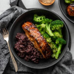 bowl filled with miso glazed salmon, purple rice, and steamed broccoli
