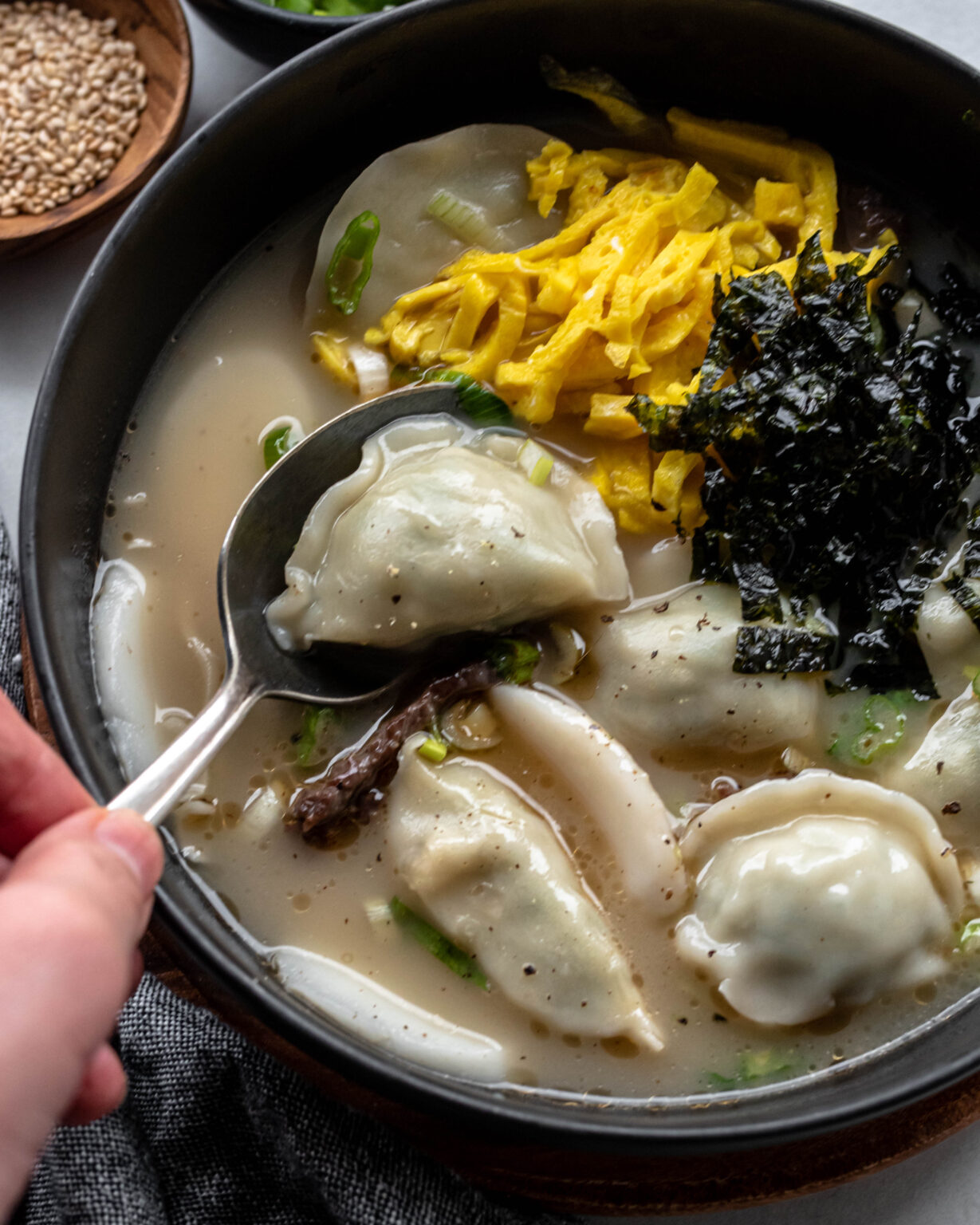 Tteok Mandu Guk (Korean Rice Cake Soup with bibigo Dumplings) The