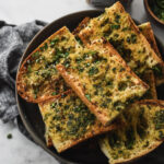bowl filled with miso garlic bread with parsley