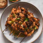 plate filled with miso chicken skewers
