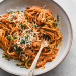 close up of creamy kimchi pasta with bacon and parmesan cheese