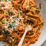 creamy kimchi pasta in bowl with fork