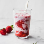 korean strawberry milk with strawberries on the side