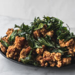 side view of taiwanese popcorn chicken with fried basil on top