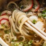 chopsticks reaching into easy udon noodle soup