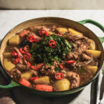 korean braised chicken (dak jjim) with perilla leaf garnish
