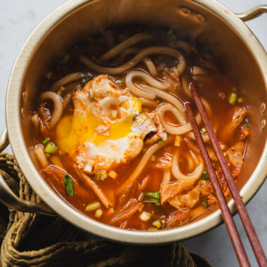 korean ramen pot filled with kimchi udon noodle soup