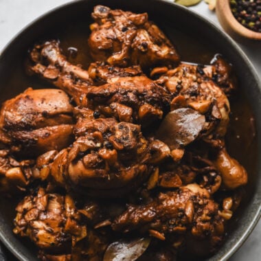 filipino chicken adobo with bay leaves, black peppercorns, and garlic