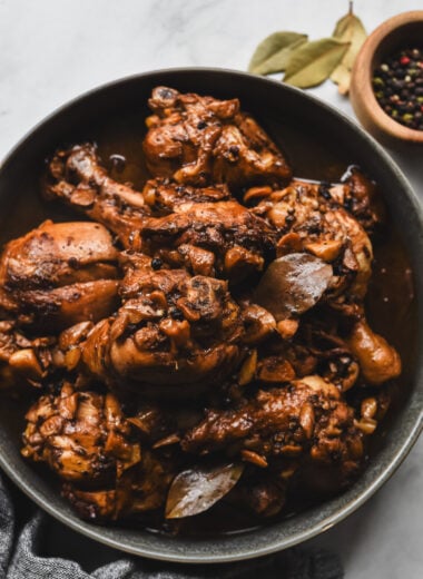filipino chicken adobo with bay leaves, black peppercorns, and garlic