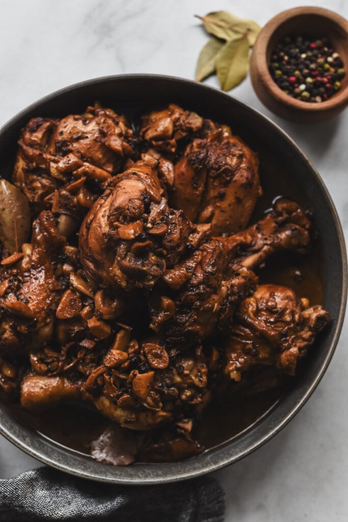 filipino chicken adobo with black peppercorns, bay leaves, and garlic