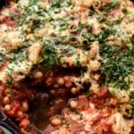 pizza beans with portion taken out in cast iron pan