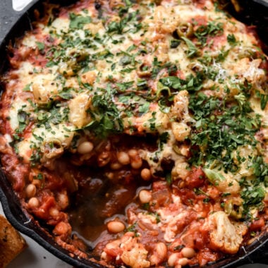cast iron pan filled with pizza beans or cheesy white bean tomato bake