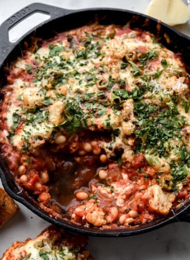 cast iron pan filled with pizza beans or cheesy white bean tomato bake