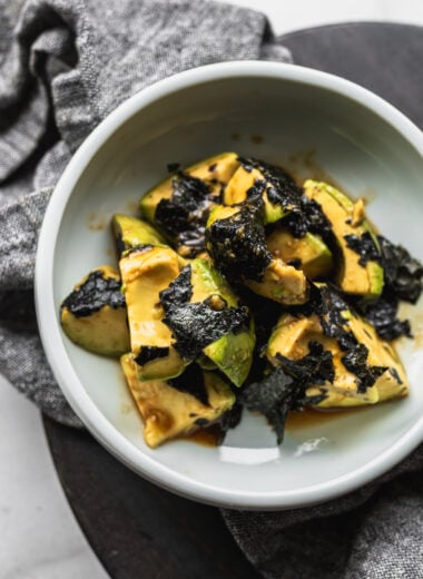 Japanese avocado salad with wasabi and nori in bowl with napkin