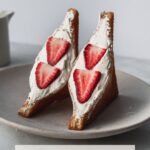 two halves of japanese fried cream sando with strawberries