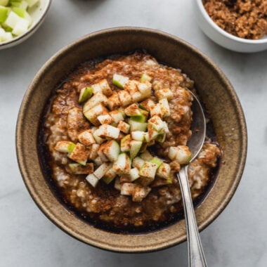 close up view of bowl with steel cut oatmeal topped with apple cinnamon