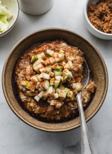 close up view of bowl with steel cut oatmeal topped with apple cinnamon