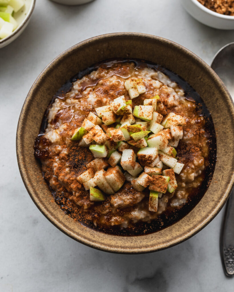 bowl of instant pot steel cut oats with apple cinnamon topping