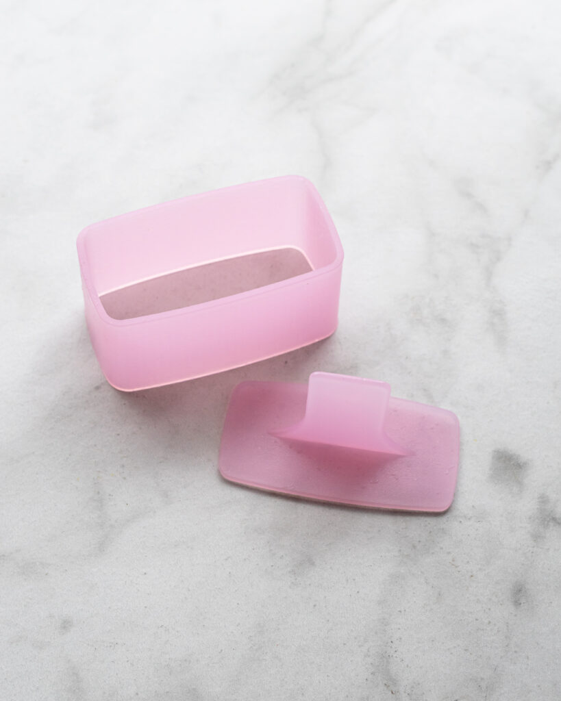 pink plastic musubi mold on counter