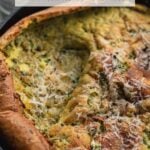 savory dutch baby pancake with herbs and parmesan in cast iron skillet