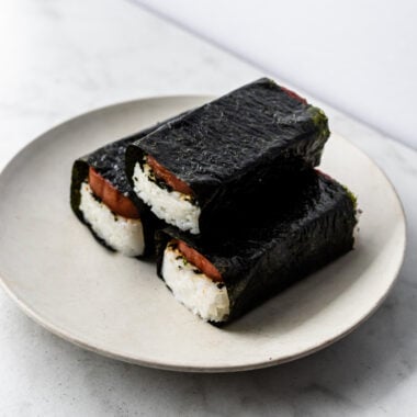 three spam musubi wrapped in nori on plate