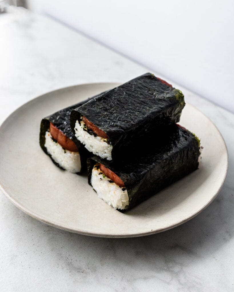 three spam musubi wrapped in nori on plate