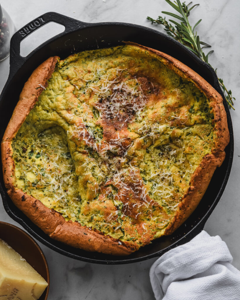 savory dutch pancake in cast iron skillet with herbs