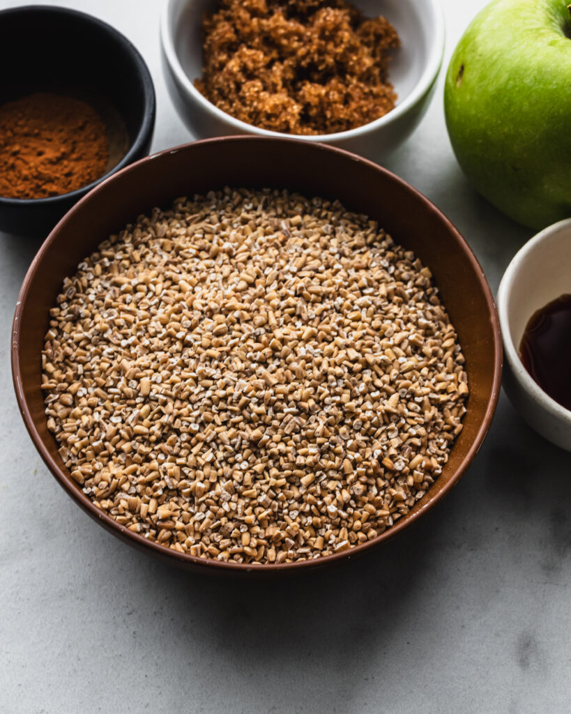 small brown bowl filled with uncooked steel cut oats