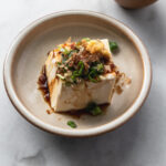 japanese cold tofu (hiyayakko) with soy sauce, green onion, ginger, and bonito flakes