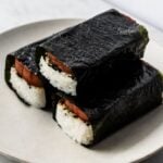 three spam musubi wrapped with nori on a plate