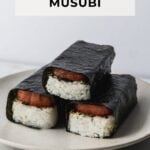 side view of three spam musubi stacked on a plate