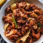 spicy korean pork in white serving bowl